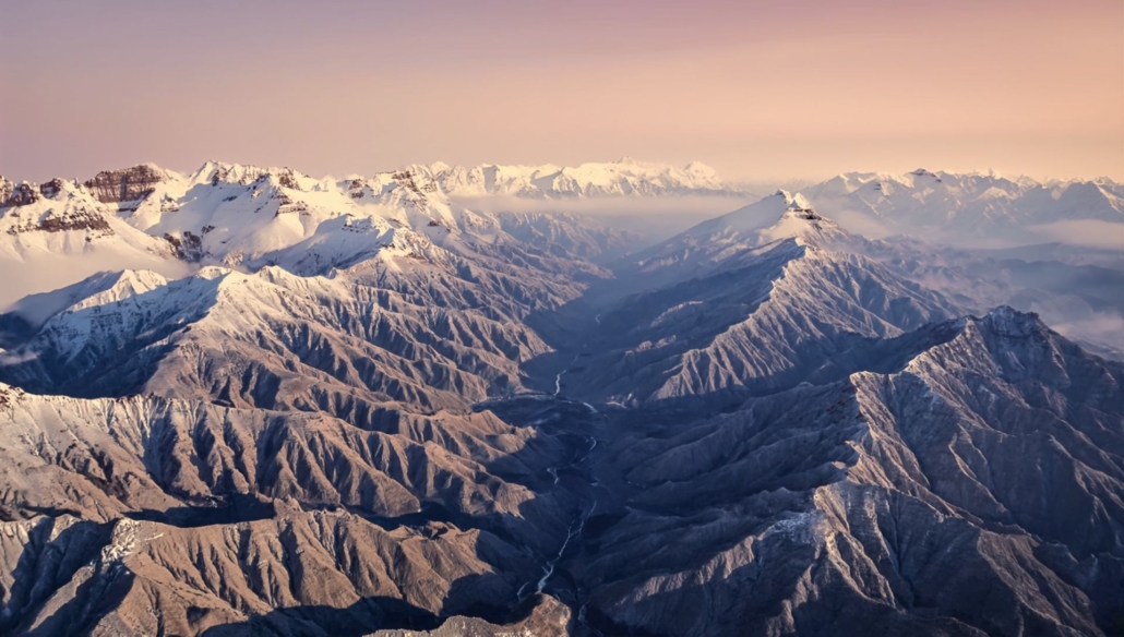 extreme high angle aerial shot of the mountains in the background of @IMG1